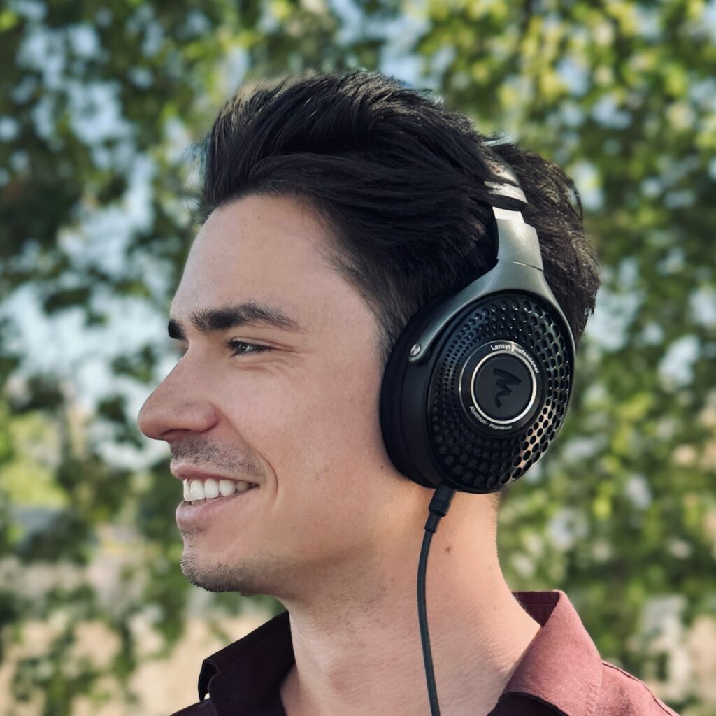 Portrait of Max Season, French composer and music producer, wearing studio headphones